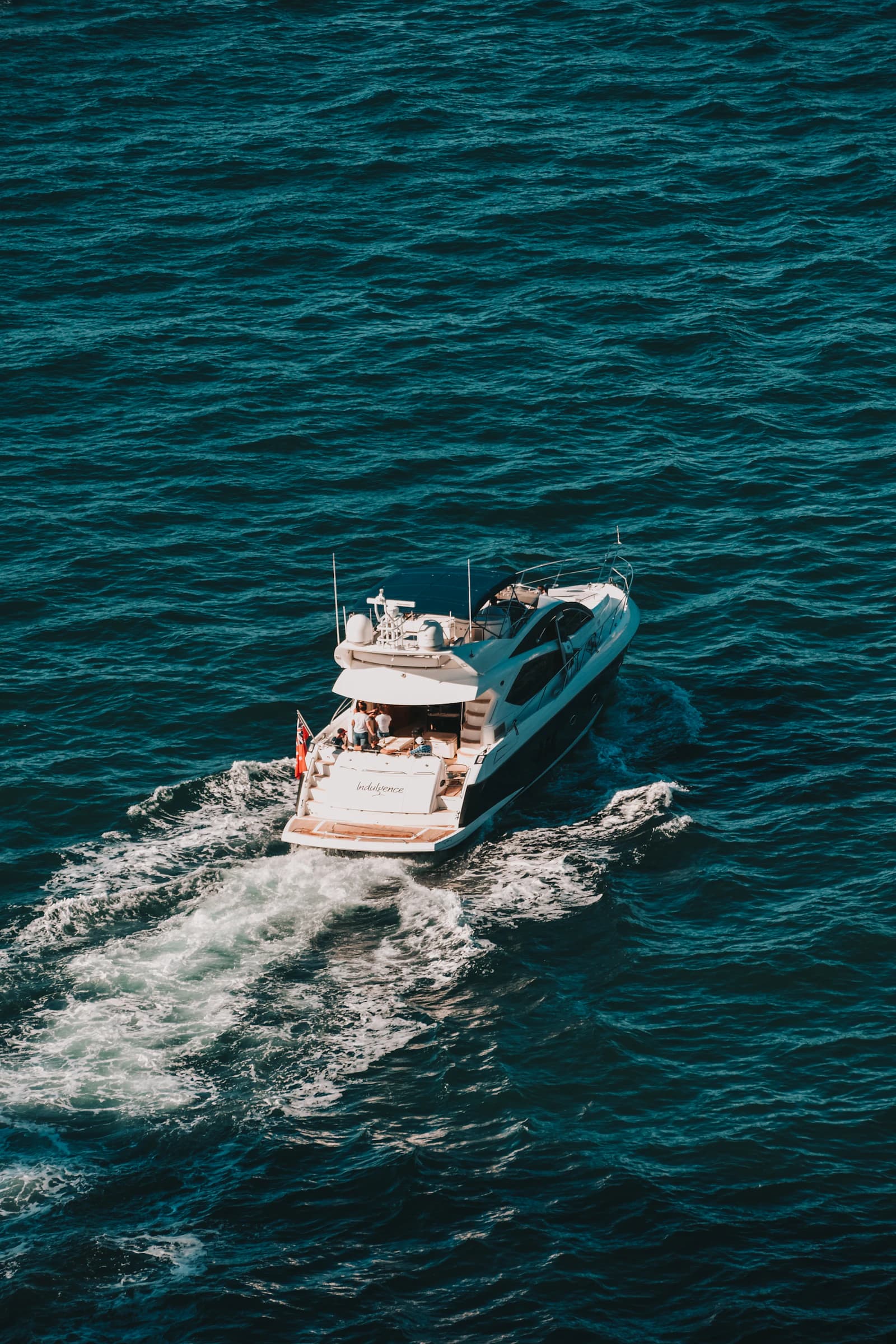 White motor yacht underway on deep Caribbean-blue water