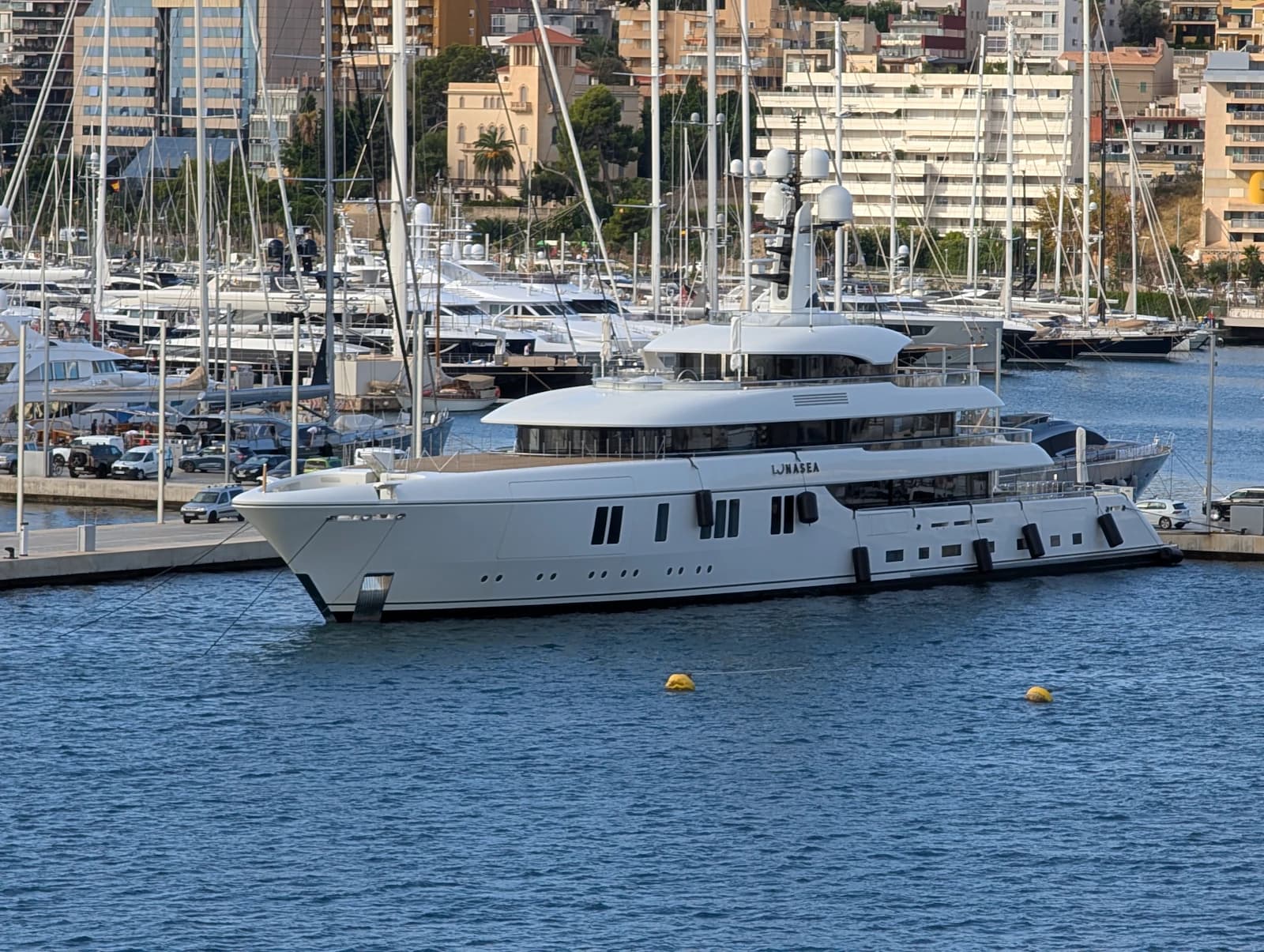 White motor yacht moored in a Mediterranean marina