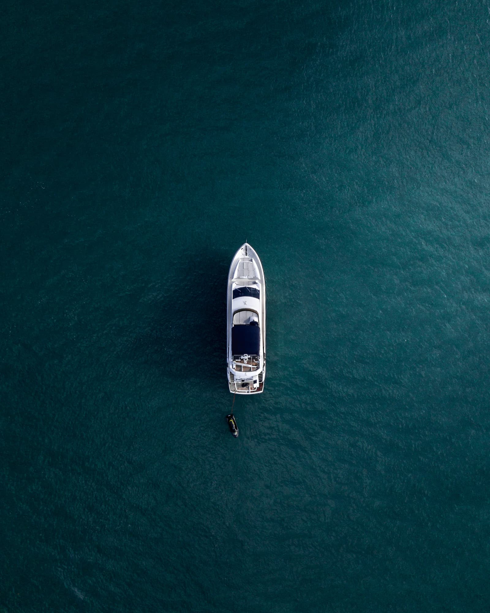 Overhead view of a white motor yacht on open water